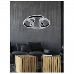 Κρεμαστό φωτιστικό μοντέρνου design με αλληλοπλεκόμενους φωτεινούς δακτυλίους, μαύρο μεταλλικό σκελετό και κρυσταλλική υφή, τοποθετημένο σε σύγχρονο καθιστικό. (Thumb 3)